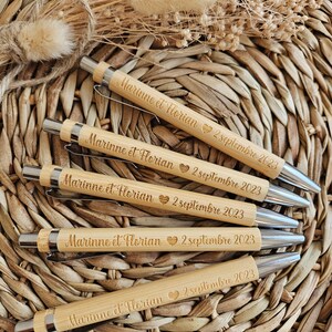 May include: Five wooden pens with silver accents. Each pen is engraved with the text "Marinne et Horian" and the date "2 septembre 2023".
