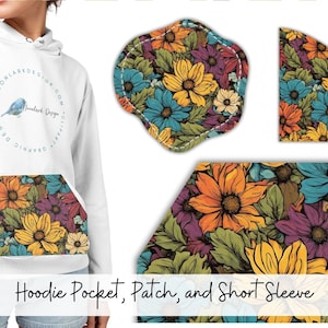 May include: White hoodie with a floral pattern on the pocket and a small patch on the sleeve. The hoodie has a blue bird graphic on the front with the text "Moonlark Design".