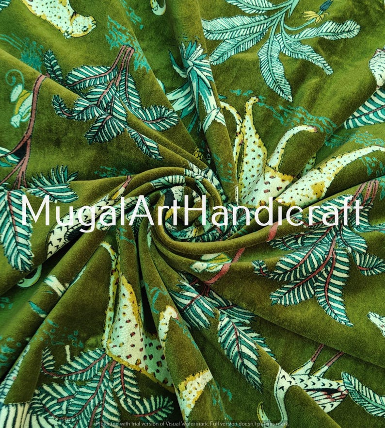 May include: Green velvet fabric with a printed design of stylized animals and plants. The fabric has a soft, plush texture and is perfect for upholstery or crafting projects.