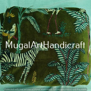 May include: Green velvet fabric with a printed design of a zebra, birds, and palm trees. The fabric has the text "MugalArtHandicraft" printed on it.