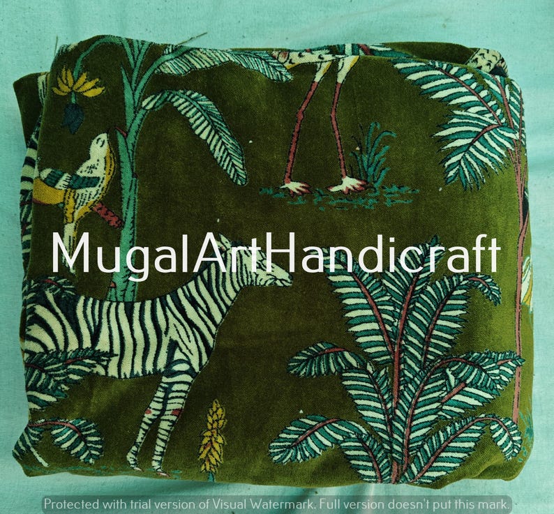 May include: Green velvet fabric with a printed design of a zebra, birds, and palm trees. The fabric has the text "MugalArtHandicraft" printed on it.