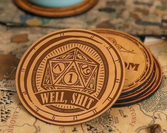 May include: A set of four brown leather coasters with a vintage design. The top coaster features a 20-sided die with the number 1 showing and the text "Well, Shit".