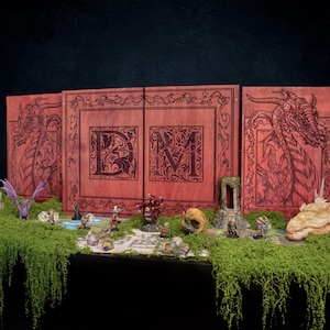 May include: A wooden DM screen with dragon illustrations and the letters "DM" is displayed. Miniature figurines and a dragon skull are arranged on a moss-covered surface, creating a fantasy game scene. The screen is red-brown.