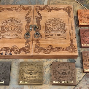 May include: Wooden dice box with engraved dice symbols and the phrases "WELL, SHIT" and "HOW I ROLL". Includes smaller wooden squares in various wood tones, labeled "Red Oak", "Alder", "Cherry", "Walnut", "Black wood", "Olive", and "Dark Walnut".