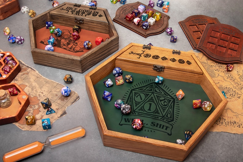 A wooden dice box featuring a dice set department with lid, elegantly accompanied with green leather positioned on a table, highlighting its craftsmanship and design. Will make a perfect gift for a DND player.