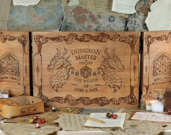 May include: A wooden box with a hinged lid, decorated with a dragon design and the text "Dungeon Master Heather The Weaver of Lore & Fate". The box is open and there are dice and other game pieces inside.