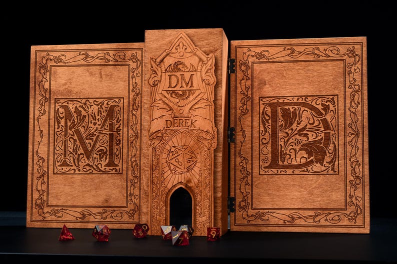 May include: A wooden DM screen with intricate carvings and the name "DEREK" engraved. The screen features the letters "M" and "D" on the side panels, with a central panel displaying "DM" and a dice tower. Several red dice are placed in front.