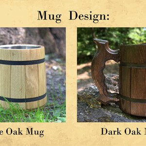 May include: Two wooden mugs with stainless steel interiors. The mug on the left is made of white oak and the mug on the right is made of dark oak. Both mugs have a black band around the middle.