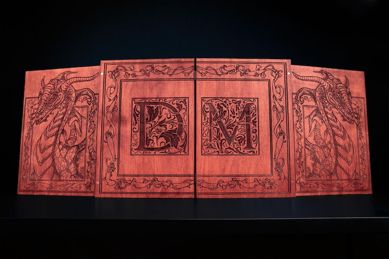 May include: A wooden game board with a reddish-brown finish. The board is divided into four panels, with dragon illustrations on the outer panels and the letters "DM" in the center. Intricate floral designs and borders frame the artwork.