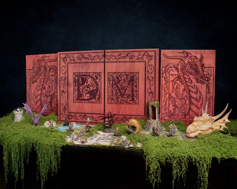 May include: A wooden DM screen with dragon illustrations and the letters "DM" is displayed. Miniature figurines and a dragon skull are arranged on a moss-covered surface, creating a fantasy game scene. The screen is red-brown.