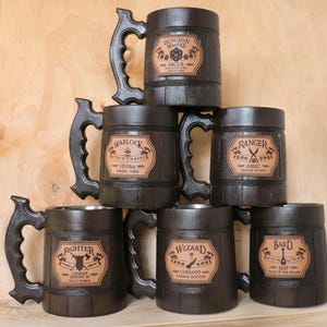 May include: Six wooden mugs with leather inlays. Each mug features a different Dungeons and Dragons character class: Dungeon Master, Warlock, Ranger, Fighter, Wizard, and Bard.