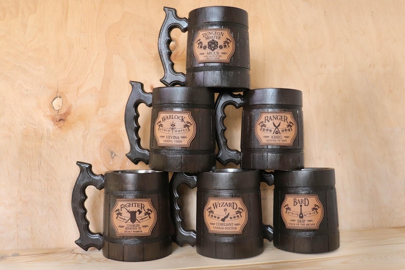 May include: Six wooden mugs with leather inlays. Each mug features a different Dungeons and Dragons character class: Dungeon Master, Warlock, Ranger, Fighter, Wizard, and Bard.