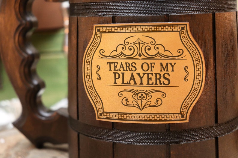 A close-up on leather label of a beer mug from Dungeons and Dragons design , featuring custom engraved design intricate designs and vibrant colors, perfect for fans of the game.