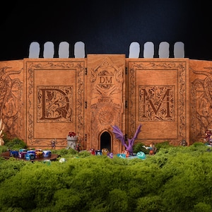May include: A wooden DM screen with dragon and letter engravings. The screen is brown with a central tower design and the letters "DM" on the front. Miniature figures and dice are arranged on a bed of green moss.