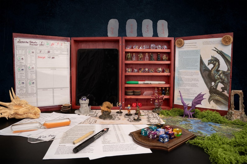 May include: A wooden tabletop role-playing game (RPG) set, featuring a red-stained wooden case with compartments for dice, miniatures, and game components. Includes a dragon illustration, character sheets, and various game pieces.