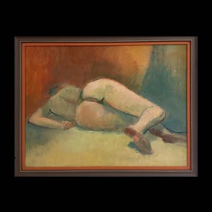 May include: An oil painting depicting a figure lying down, seen from behind. The figure is painted in soft beige, green, and brown tones, with a gentle, painterly technique. The artwork is presented in a brown wooden frame.