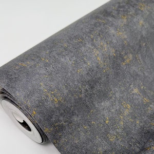 May include: A roll of dark gray wallpaper with a subtle gold fleck pattern. The wallpaper is rolled up and the end of the roll is visible.