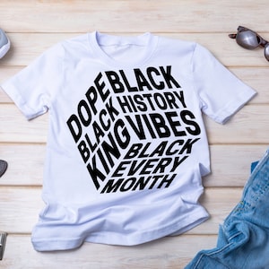 May include: White t-shirt with black text that reads "Dope Black Black History King Vibes Black Every Month".