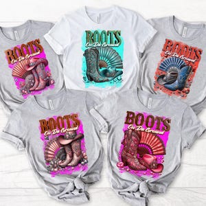 May include: Five gray t-shirts with a colorful graphic design of boots, a fan, and rhinestones. The text "BOOTS On Da Ground" is printed on each shirt.