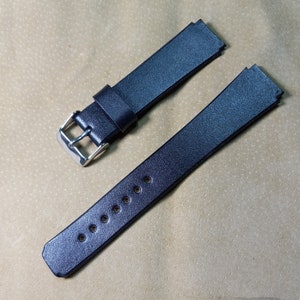 May include: Two black leather watch bands with silver buckles. One band has a straight end and the other has a curved end.