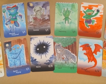 May include: A set of 10 watercolor illustrated cards featuring fantasy creatures and objects. The cards are printed on white cardstock and have a light brown background. The cards include a vampire, a merfolk, a zombie, a saproling, a goblin, a myr, an angel, a spirit, a derm, a wolf, a dragon, and a treasure chest.