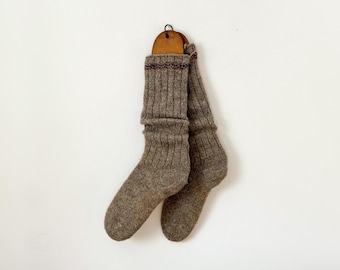 Antique pair of hand-knitted wool socks on wood stretchers: gray with blue and brown stripes, from Québec Canada, circa 1930s-40s
