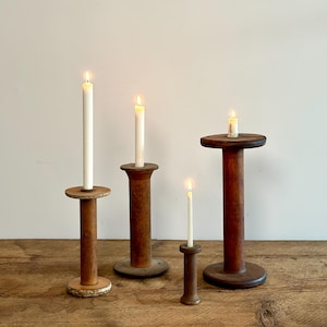 Collection of four antique industrial textile mill bobbins, spools made of wood and metal, primitive candle holders, circa early 1900s