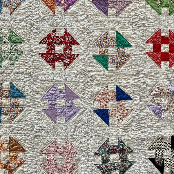 Antique churn dash block pattern quilt, machine assembled and hand-quilted, with colorful cotton fabrics, circa 1940s or 50s