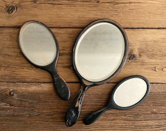 Set of three antique hand mirrors, with bevelled glass and wooden frames