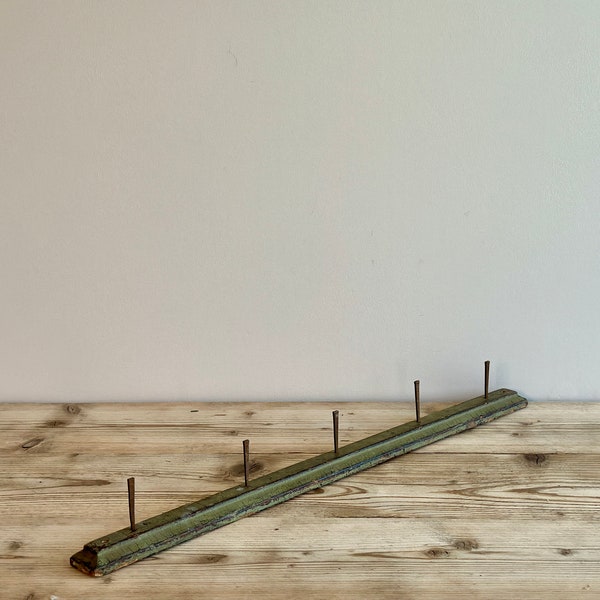 Antique primitive wood coat rack with metal square nail pegs and with its original green paint, circa late 1800s-early 1900s