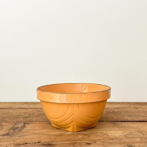 Antique yellowware mixing bowl with orange glaze and Art Deco designs, unmarked but likely by Watt, Ohio, USA, circa 1920s
