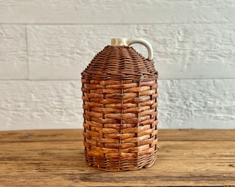 Rare antique handwoven wicker ironstone jug or bottle, with a finger handle, white ceramic wrapped bottle in wicker, circa early 1900s