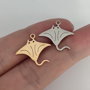 May include: Two metal stingray charms, one gold and one silver, with a loop for attaching to jewelry.