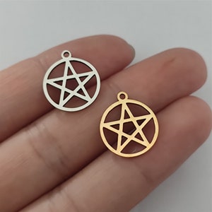May include: Two metal charms in the shape of a pentagram. One charm is silver and the other is gold.