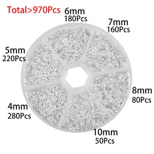 May include: A clear plastic container with six compartments filled with silver jump rings. The container is labeled with the total number of jump rings, "Total>970Pcs", and the size and quantity of each size of jump ring. The sizes are 4mm, 5mm, 6mm, 7mm, 8mm, and 10mm.
