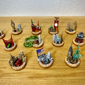 12 major city miniatures for board games like Fortune and Glory