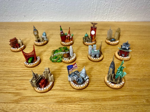 12 major city miniatures for board games like Fortune and Glory
