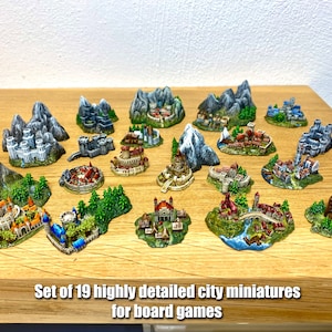 May include: Set of 19 highly detailed city miniatures for board games. The miniatures are painted in various colors and feature different styles of buildings and landscapes.