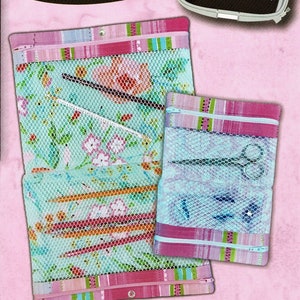 May include: Two mesh cases with floral and striped patterns. The cases have pink and green accents, zippers, and a snap closure. One case contains scissors. The text reads "Pickle Pie Designs" and "Exclusive Hoop Envy Design CD!"