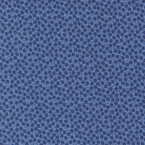 May include: A close-up of a blue fabric with a repeating pattern of small, dark blue floral shapes. The background is a lighter shade of blue, creating a textured appearance. The fabric is likely cotton or a similar material.