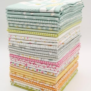 May include: A stack of 20 fabric squares in various patterns and colors, including green, yellow, pink, and white. The fabric squares feature small floral patterns, geometric patterns, and text.