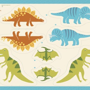 May include: A fabric panel featuring dinosaur cutouts in various colors. The panel includes a brown Stegosaurus, blue Triceratops, green Tyrannosaurus Rex, and green Pterodactyls. The background is off-white with a blue border.