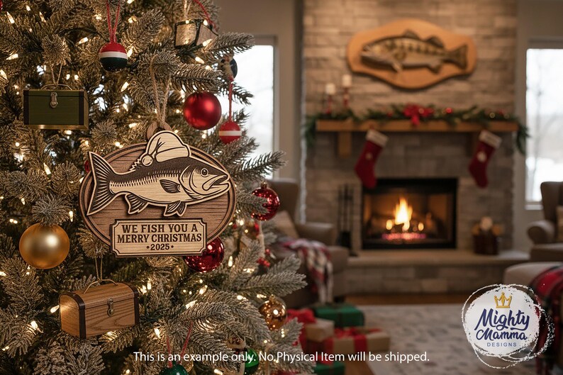 May include: Wooden Christmas ornament featuring a fish wearing a Santa hat. The ornament reads "We Fish You a Merry Christmas - 2025." The ornament is hanging on a decorated Christmas tree with other ornaments and lights.
