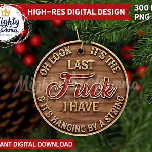 May include: A round wooden Christmas bauble with the text "Oh look it's the last f*** I have & it's hanging by a string".