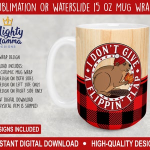May include: A sublimation or waterslide design for a 15 oz ceramic mug wrap featuring a cartoon beaver wearing a red toque and holding a maple leaf. The design includes the text "I don't give a flippin' flap" in a red circle with a black and red plaid background.
