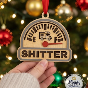 May include: Wooden Christmas ornament with a gauge design and the word "SHITTER". The gauge shows a camper van icon and a red needle. The ornament is hanging from a red ribbon. The text "This is an sample only. No Physical Item will be shipped." is at the top.