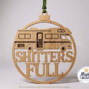 May include: Wooden Christmas ornament in the shape of a circle with a cutout of a recreational vehicle. The words "SHITTERS FULL" are cut out below the RV. A green ribbon is attached for hanging. The Mighty Mamma Designs logo is in the bottom right.
