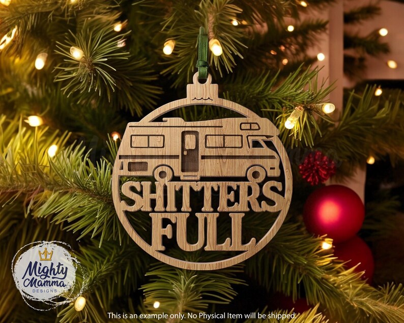 May include: A wooden Christmas ornament shaped like a camper van with the words "SHITTERS FULL" cut out. The ornament hangs from a green ribbon against a backdrop of a Christmas tree with lights and red ornaments.