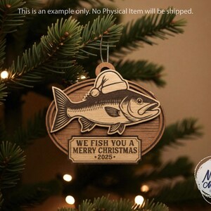May include: Wooden Christmas ornament featuring a fish wearing a Santa hat. The ornament has the text "WE FISH YOU A MERRY CHRISTMAS 2025". The ornament is hanging on a Christmas tree.