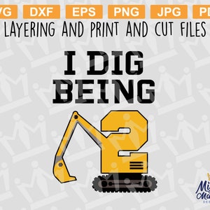 May include: A yellow excavator with a black number "2" on the side. The text "I DIG BEING" is above the excavator. The text "Mighty Mamma Designs" is in the bottom right corner of the image.